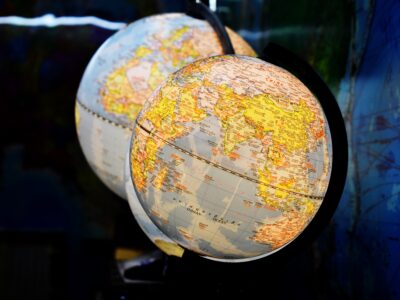 shallow focus photography of two desk globe